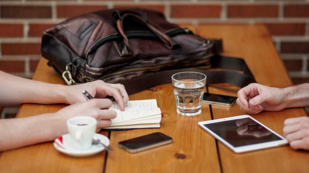 People working together at a table with laptops